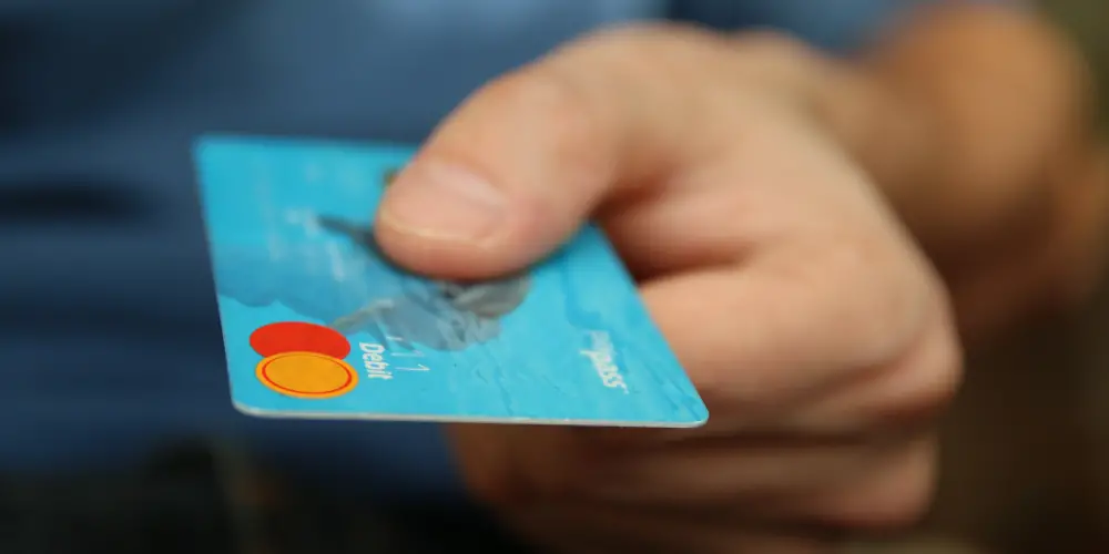 a man handing his debit card