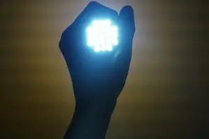 a hand holding a flash LED light